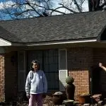 Phyllis and John showing off her new roof.